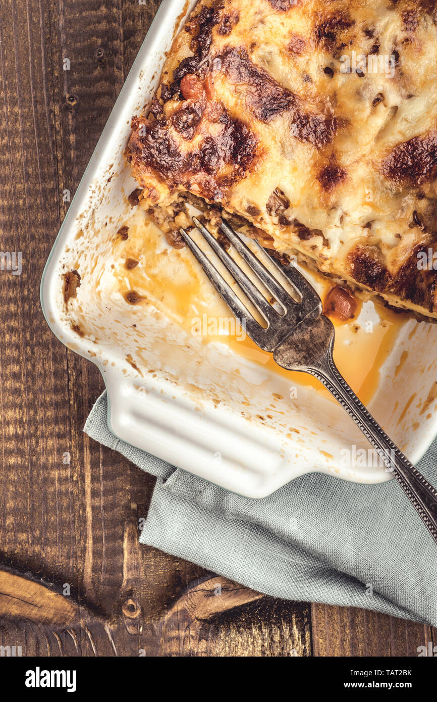 Rustic Italian Lasagna Bolognese on Dark Wooden Background Stock Photo