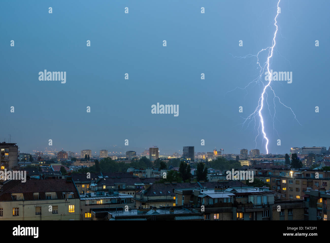 Lightning Thunderbolt Flash Strike Over City in the Night. Weather Concept. Stock Photo