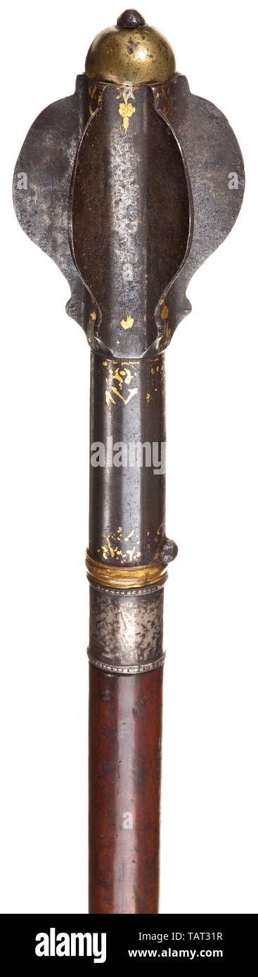 A Mamluk mace, 18th century, Forged iron, the six flanges of semicircular form, topped by a half bronze orb, long, partially facetted socket, gilt bronze ring over silver ferrule, gold inlaid flower ornaments, the hardwood grip with pierced hole for a lanyard. Length 64 cm. Provenance: From Napoleon's Egyptian campaign 1798 - 1801. A very similar Mamluk mace is housed in the Musée de l'Armée in Paris (K843-A12694) and is depicted and described in 'Les armées francaises Ã  L'époque révolutionnaire', published by the Musée de l'Armée Paris 1989, p., Additional-Rights-Clearance-Info-Not-Available Stock Photo