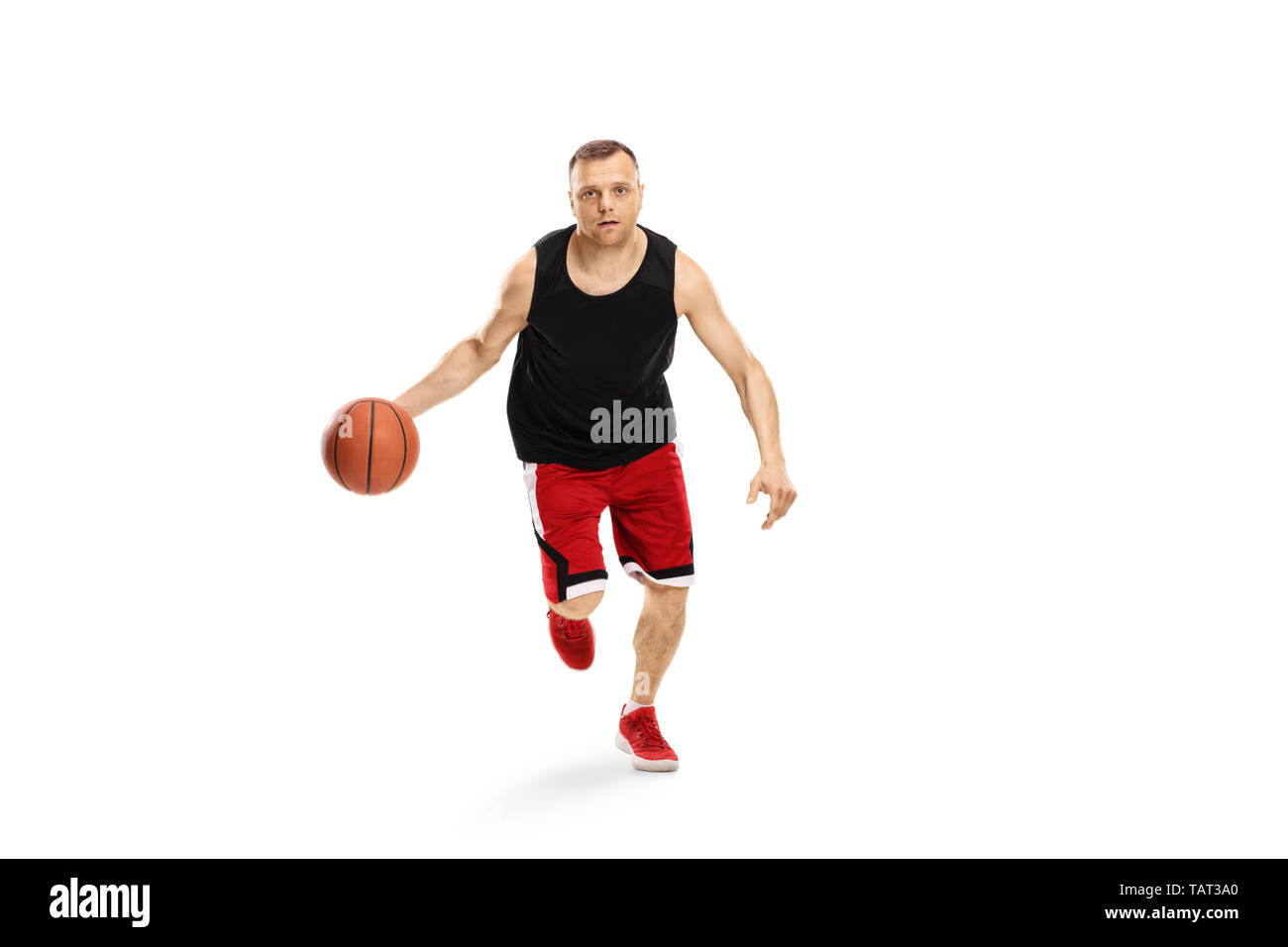 Full length portrait of a man running towards the camera with a basketball isolated on white background Stock Photo