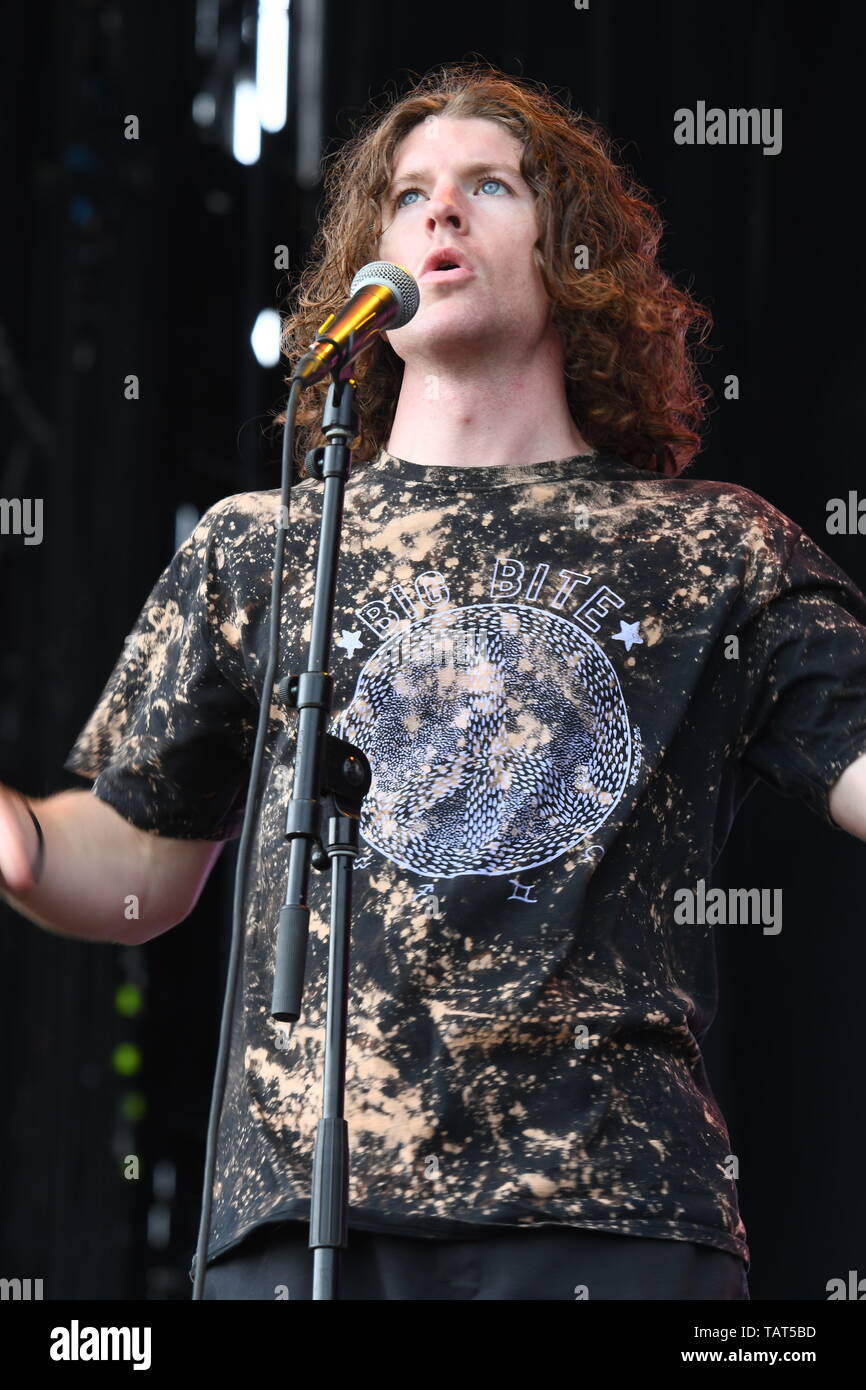 Singer Brendan Yates is shown performing on stage during a "live" stand