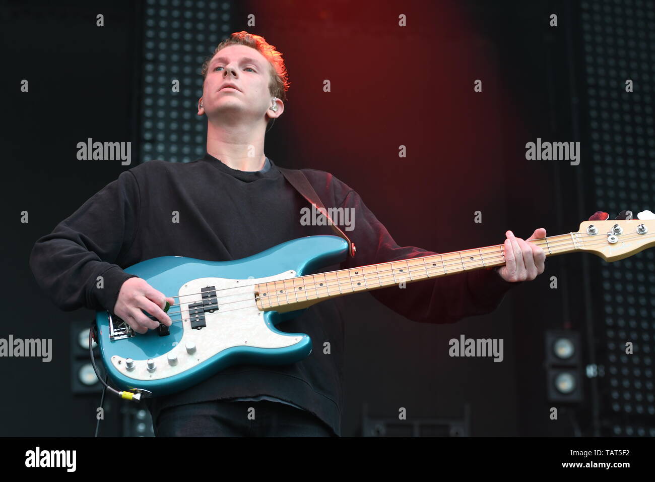 Bass guitarist Charlie Wood is shown performing on stage during a