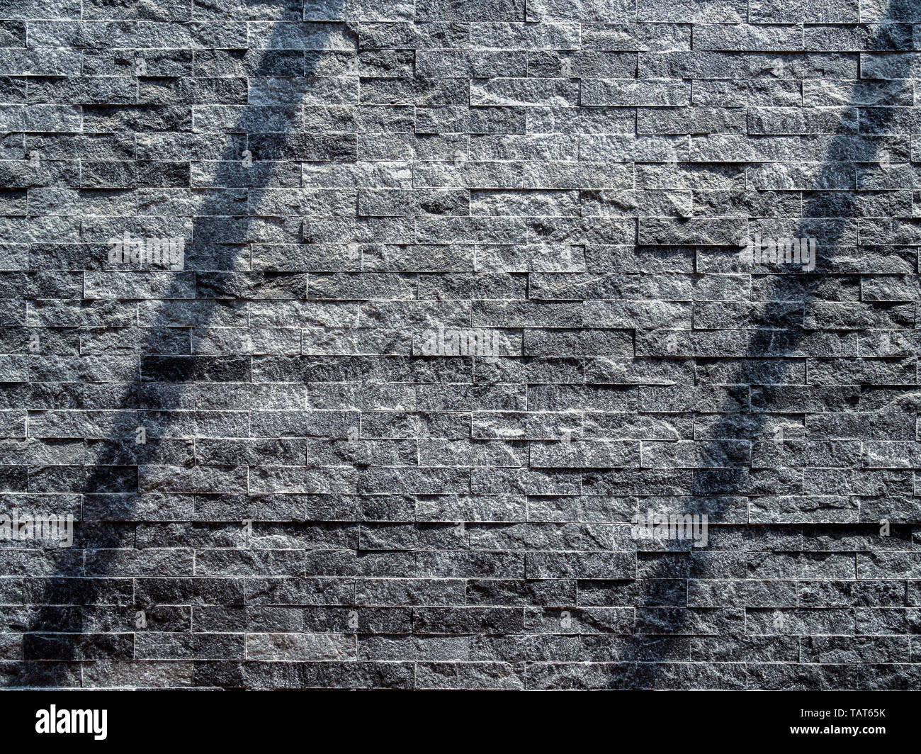 Modern grey brick wall texture background. Shadow shade light on stone  brick tiles texture. Minimalist style wall background with copy space Stock  Photo - Alamy