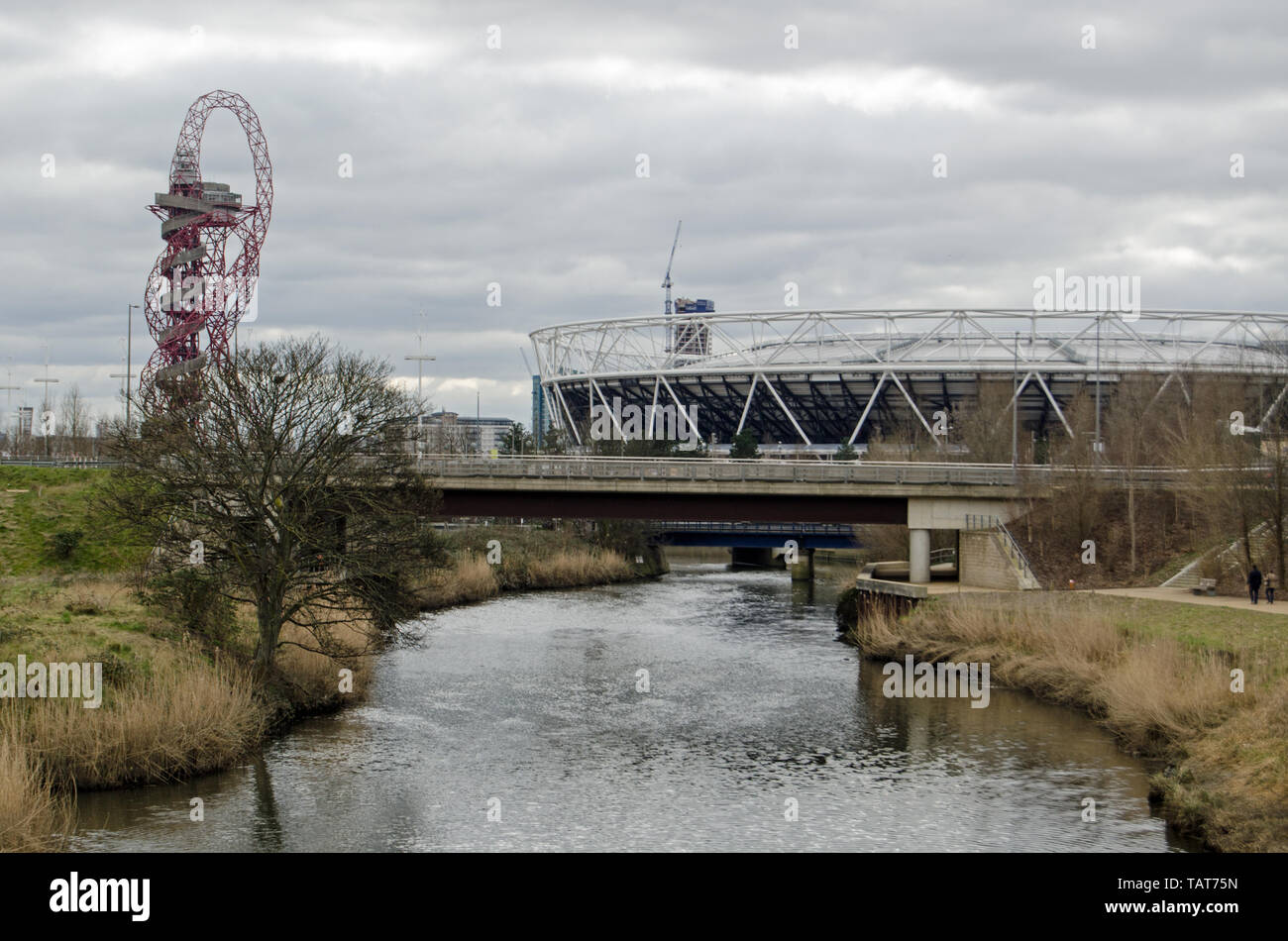 LONDON, UK - MARCH 19, 2016:  View along the River Lea towards the London Stadium and Orbit structure in Queen Elizabeth Olympic Park, Stratford. Stock Photo