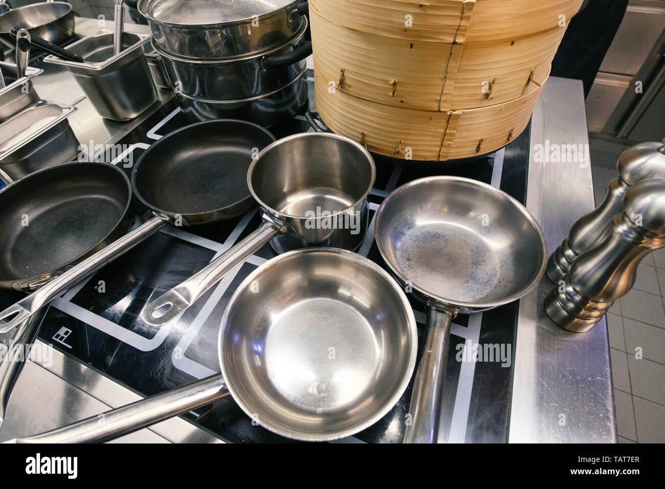 Pots, pans and dim sum baskets waiting in a kitchen to be used. Stock Photo