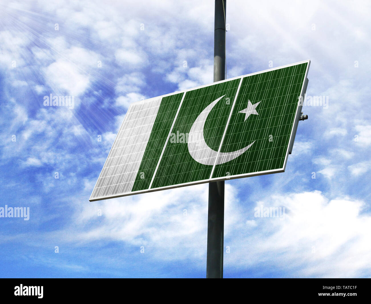 Solar panels against a blue sky with a picture of the flag of Pakistan ...