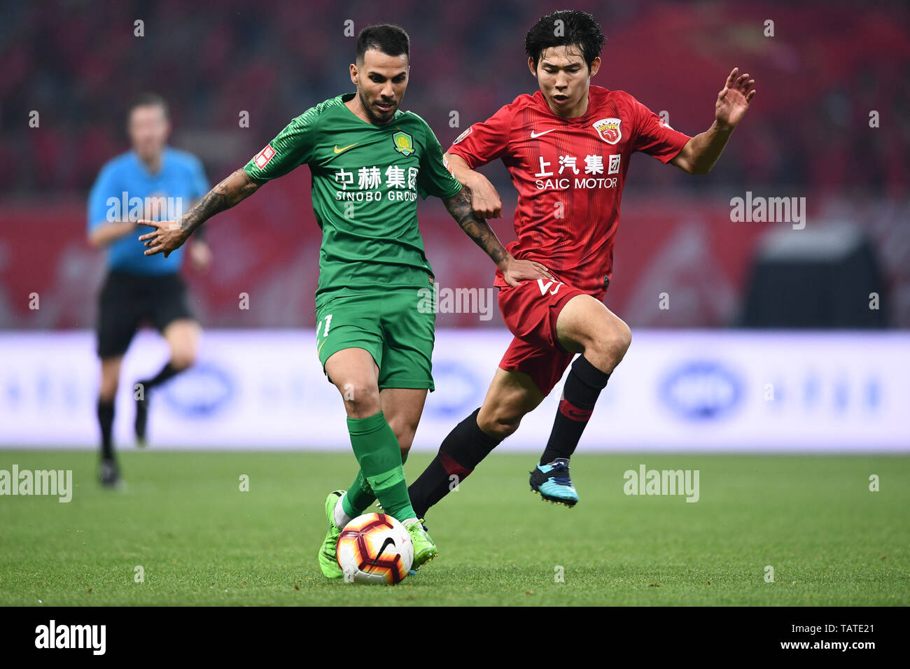 Brazilian football player Renato Soares de Oliveira Augusto, or simply Renato Augusto, left, of Beijing Sinobo Guoan challenges a player of Shanghai SIPG in their 11th round match during the 2019 Chinese Football Association Super League (CSL) in Shanghai, China, 26 May 2019.  Shanghai SIPG defeated Beijing Sinobo Guoan 2-1. Stock Photo
