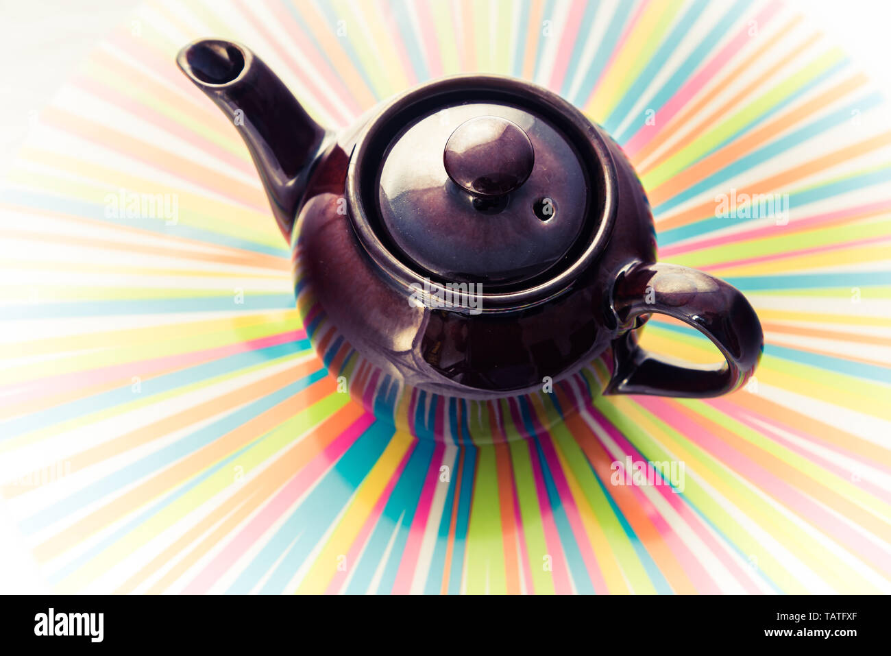 Antique teapot - luxury ceramic kettle on rainbow background Stock Photo