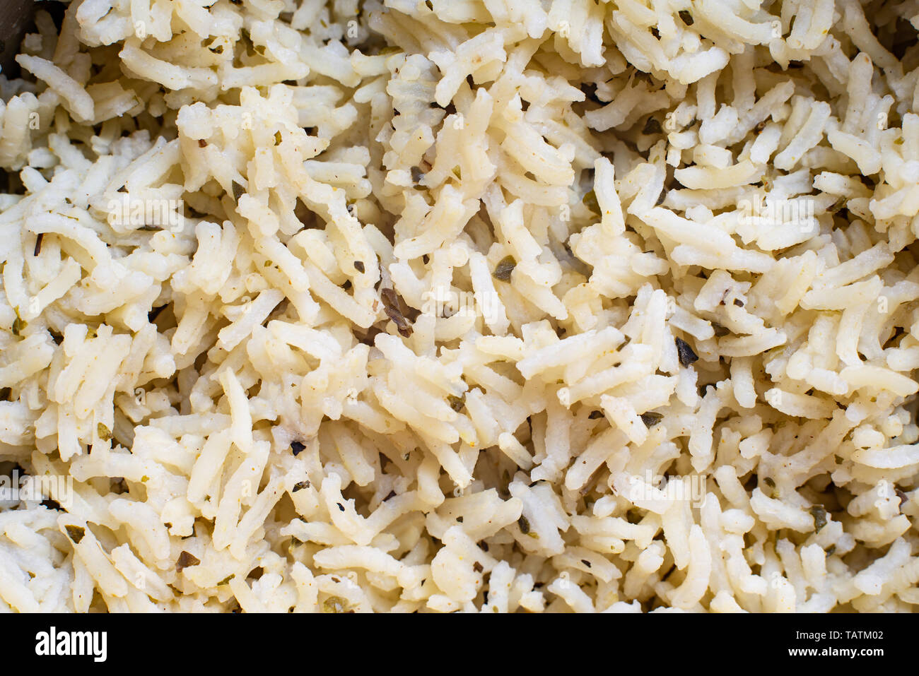 Closeup of a handful of basmati rice cooked with spices, background for Asian menus and