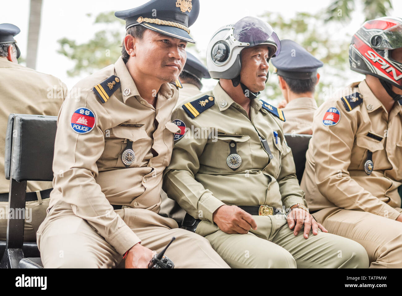 Phnom Penh, Cambodia - January 17, 2019: a group of Cambodian policemen sits on the bench in the pickup's body. Stock Photo