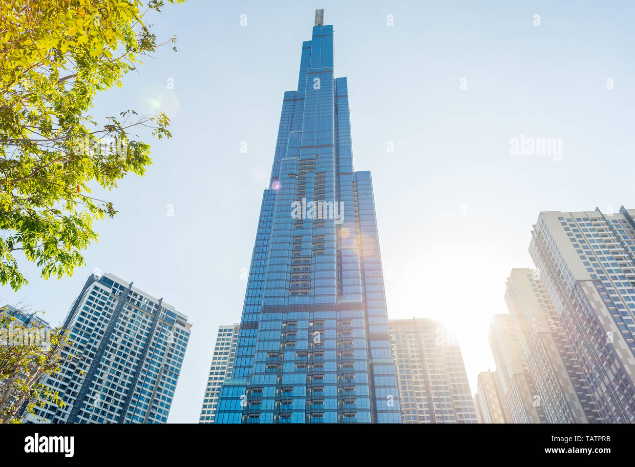 Ho Chi Minh City, Vietnam - February 19, 2019: Landmark 81 and other Vinhomes Central Park high-rise buildings, with the sun shining and lens flares. Stock Photo