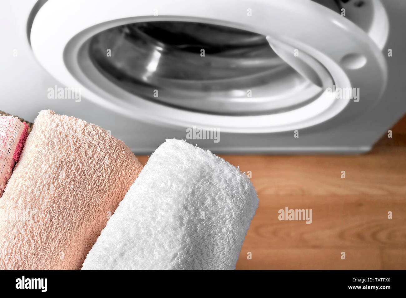Top View Of Clean Towels And Washing Machine At Laundry Room