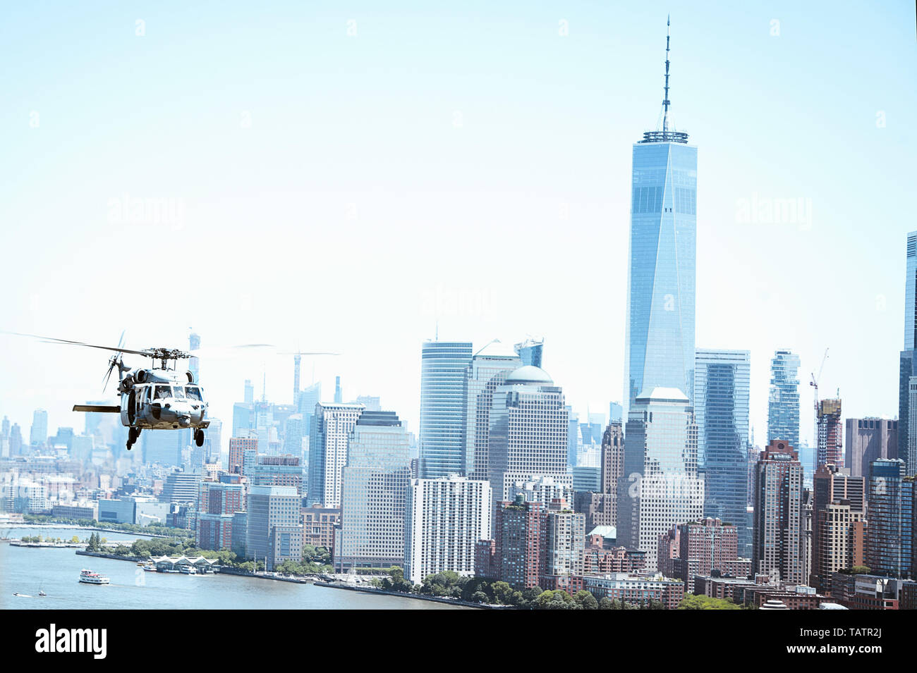 190526-N-XQ474-1196 NEW YORK (May 26, 2019) An MH-60S Sea Hawk helicopter assigned to the 'Tridents' of Helicopter Sea Combat Squadron (HSC) 9 flies over New York City during Fleet Week New York. Fleet Week New York, now in its 31st year, is the city's time-honored celebration of the sea services. It is an unparalleled opportunity for the citizens of New York and the surrounding tri-state area to meet Sailors, Marines and Coast Guardsmen, as well as witness firsthand the latest capabilities of today's maritime services. (U.S. Navy photo by Mass Communication Specialist 2nd Class Andrew Schneid Stock Photo
