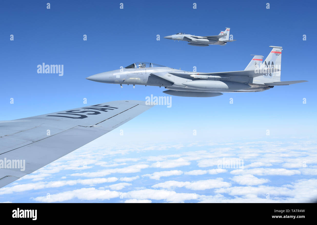 Two Massachusetts Air National Guard F-15 Eagles join in formation alongside the wing of a New Jersey Air National Guard KC-135R Stratotanker on May 24, 2019 in support of Arctic Challenge Exercise 2019. ACE 19 is intended to provide scenario-based training to prepare partner forces for enemy defensive systems. (U.S. Air National Guard photo by Senior Airman Maria Rella). Stock Photo