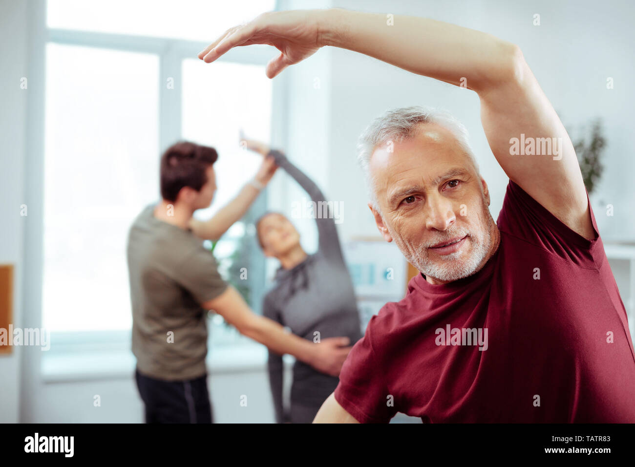 Healthy lifestyle. Handsome mature man exercising while trying to be fit Stock Photo