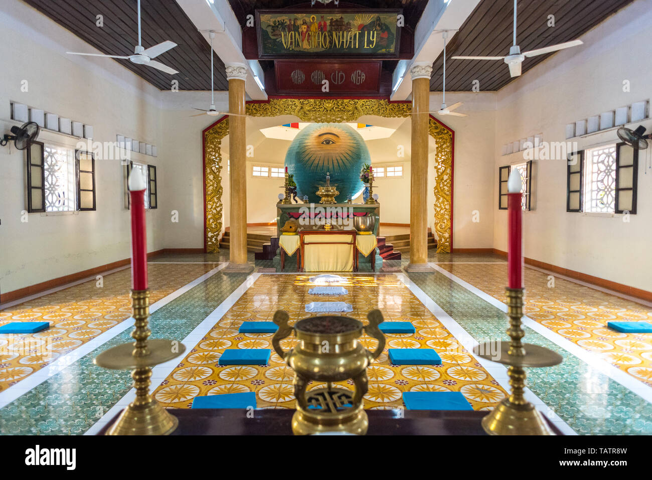 Da Nang, Vietnam - March 25, 2019: an interior of Trung Hung Buu Toa Cao Dai, a Caodaist temple, with the sphere of Left Eye of God in the center. Stock Photo