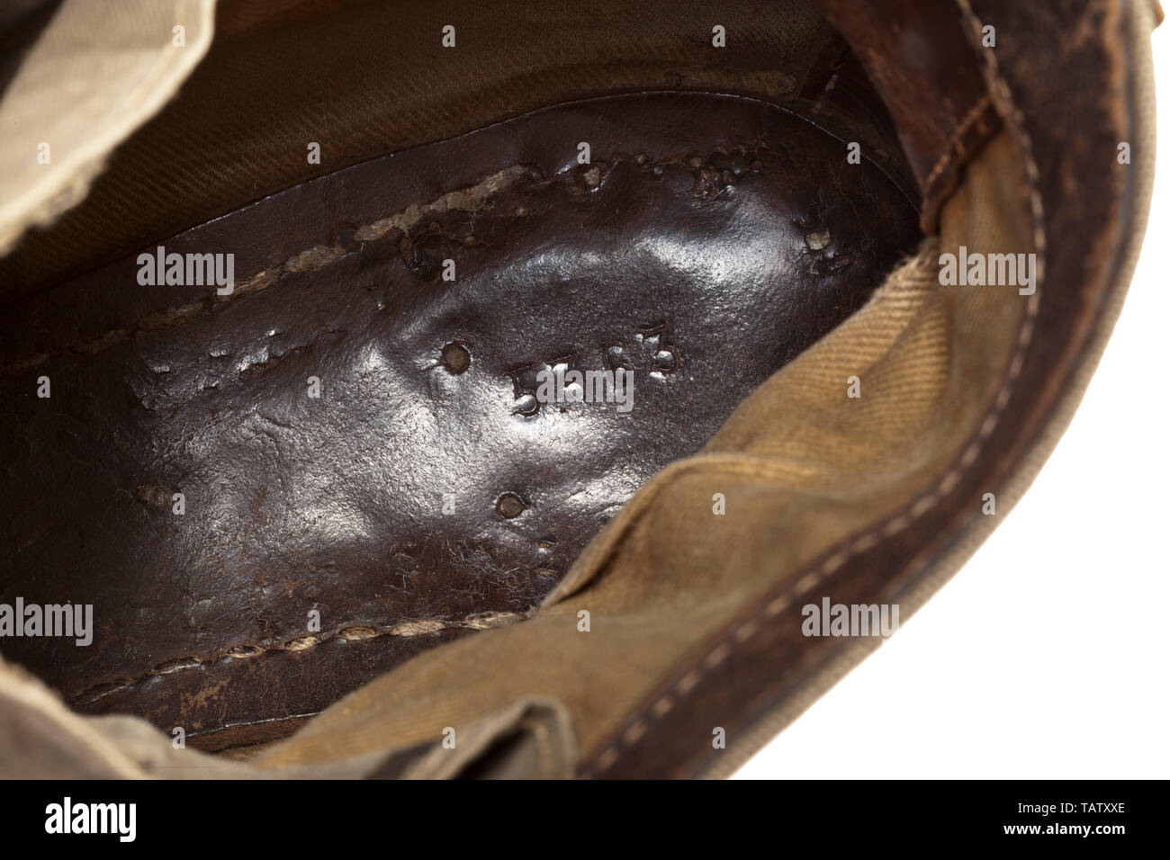 A pair of shoes to the tropical uniform for army members, Lower parts and reinforcements in smooth, brown leather, khaki-coloured canvas shafts with black painted iron eyelets (filmed with rust) and hooks for lacing. The inner sole stamped '5363'. Several of the nails are missing from the sole. historic, historical 20th century, Additional-Rights-Clearance-Info-Not-Available Stock Photo