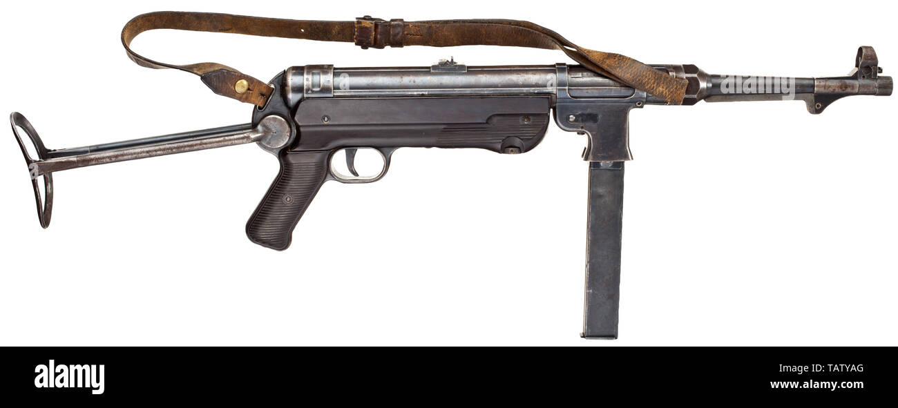 An original machine pistol Mod. 40 (MP 40), 1st issue, code 'ayf 41', Cal. 9 mm parabellum, no. 6369c. Matching numbers except for the breech. Bright bore. 32-shot. Fixed sight with one flap, scaled 100 - 200. First issue: smooth magazine well, hooked bolt handle. Marked 'MP 40 / ayf / 41' on the casing, 1941 production series by Erma, Erfurt. Acceptance mark eagle/WaA280 with further markings by the supplier. Original finish with signs of usage, partially stained and patinated. Stock and grip plates made of dark brown Bakelite. Original strap. C, Additional-Rights-Clearance-Info-Not-Available Stock Photo