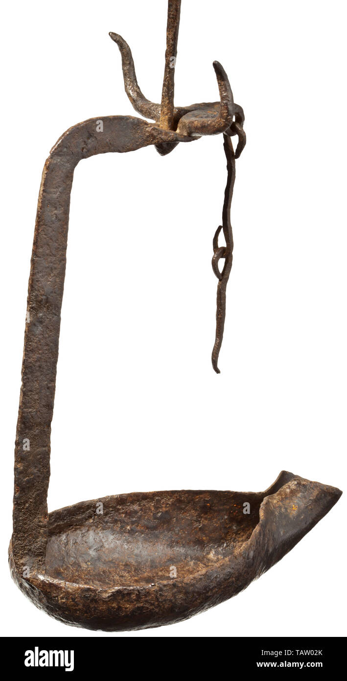 An Early Byzantine iron oil lamp with a bull's head, 5th - 6th century, Forged lamp with open bowl and nozzle. L-shaped bracket attached at back, terminating at top in a stylised bull's head. The head bent into an eyelet at front, to which two hooked chain links are attached which previously held the wick. The back of the head with a hole into which the lowest of three rods, all twisted at centre, is inserted with a terminal knob. The suspension rods linked to each other by eyelets. The top rod terminating in a hook which can be attached to a protrusion like a miner's lamp., Editorial-Use-Only Stock Photo