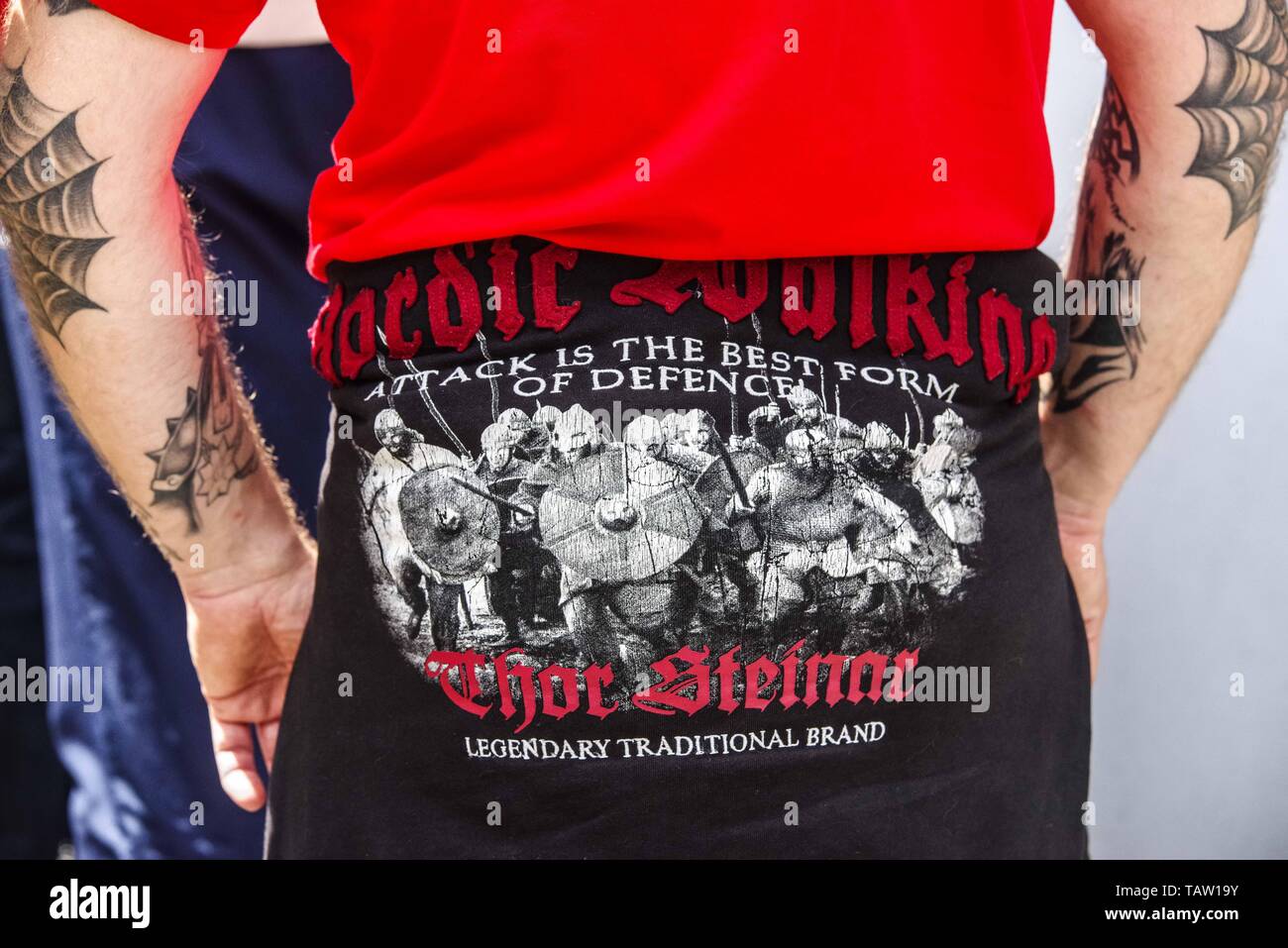 Dortmund, Nordrhein Westfalen, Germany. 25th May, 2019. A neonazi in Dortmund, Germany wears a shirt from the company Thor Steinar, which is marketed towards right-extremists. Prior to the European Elections, the neonazi party Die Rechte (The Right) organized a rally in the German city of Dortmund to promote their candidate, the incarcerated Holocaust denier Ursula Haverbeck. The demonstration and march were organized by prominent local political figure and neonazi activist Michael Brueck (Michael BrÃ¼ck) who enlisted the help of not only German neonazis, but also assistance from Russian, Bul Stock Photo