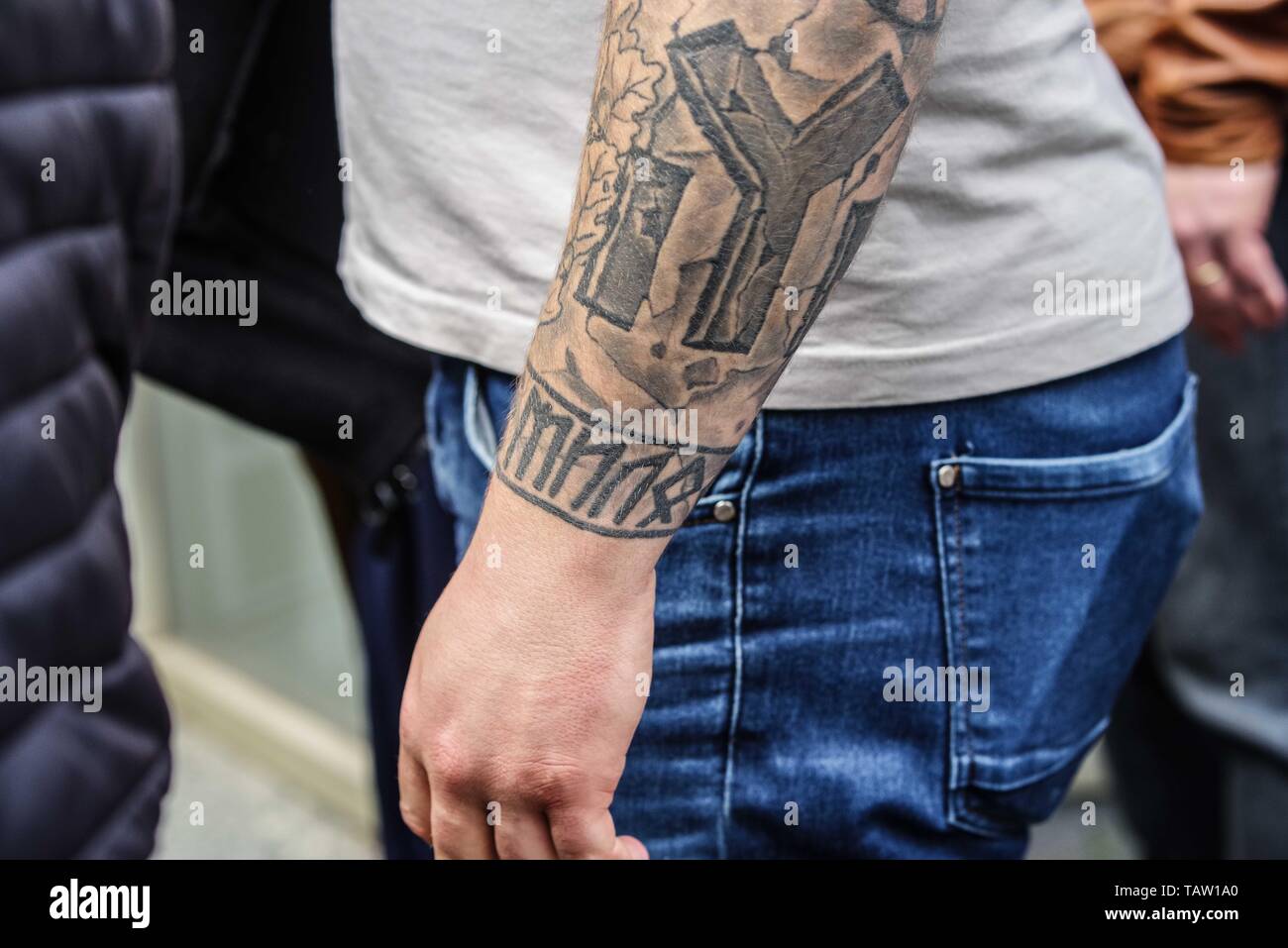 Dortmund, Nordrhein Westfalen, Germany. 25th May, 2019. Tattoos on a Bulgarian neonazi, including Runes. Prior to the European Elections, the neonazi party Die Rechte (The Right) organized a rally in the German city of Dortmund to promote their candidate, the incarcerated Holocaust denier Ursula Haverbeck. The demonstration and march were organized by prominent local political figure and neonazi activist Michael Brueck (Michael BrÃ¼ck) who enlisted the help of not only German neonazis, but also assistance from Russian, Bulgarian, Hungarian, and Dutch groups with the final tally ranging from 1 Stock Photo