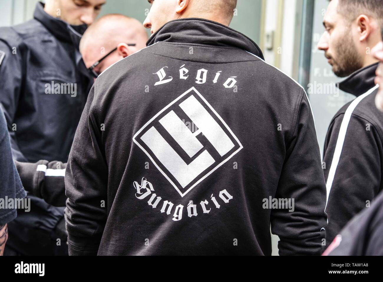Dortmund, Nordrhein Westfalen, Germany. 25th May, 2019. Symbol of a Hungarian neonazi group ''Legio Hungaria''. Prior to the European Elections, the neonazi party Die Rechte (The Right) organized a rally in the German city of Dortmund to promote their candidate, the incarcerated Holocaust denier Ursula Haverbeck. The demonstration and march were organized by prominent local political figure and neonazi activist Michael Brueck (Michael BrÃ¼ck) who enlisted the help of not only German neonazis, but also assistance from Russian, Bulgarian, Hungarian, and Dutch groups with the final tally rangin Stock Photo