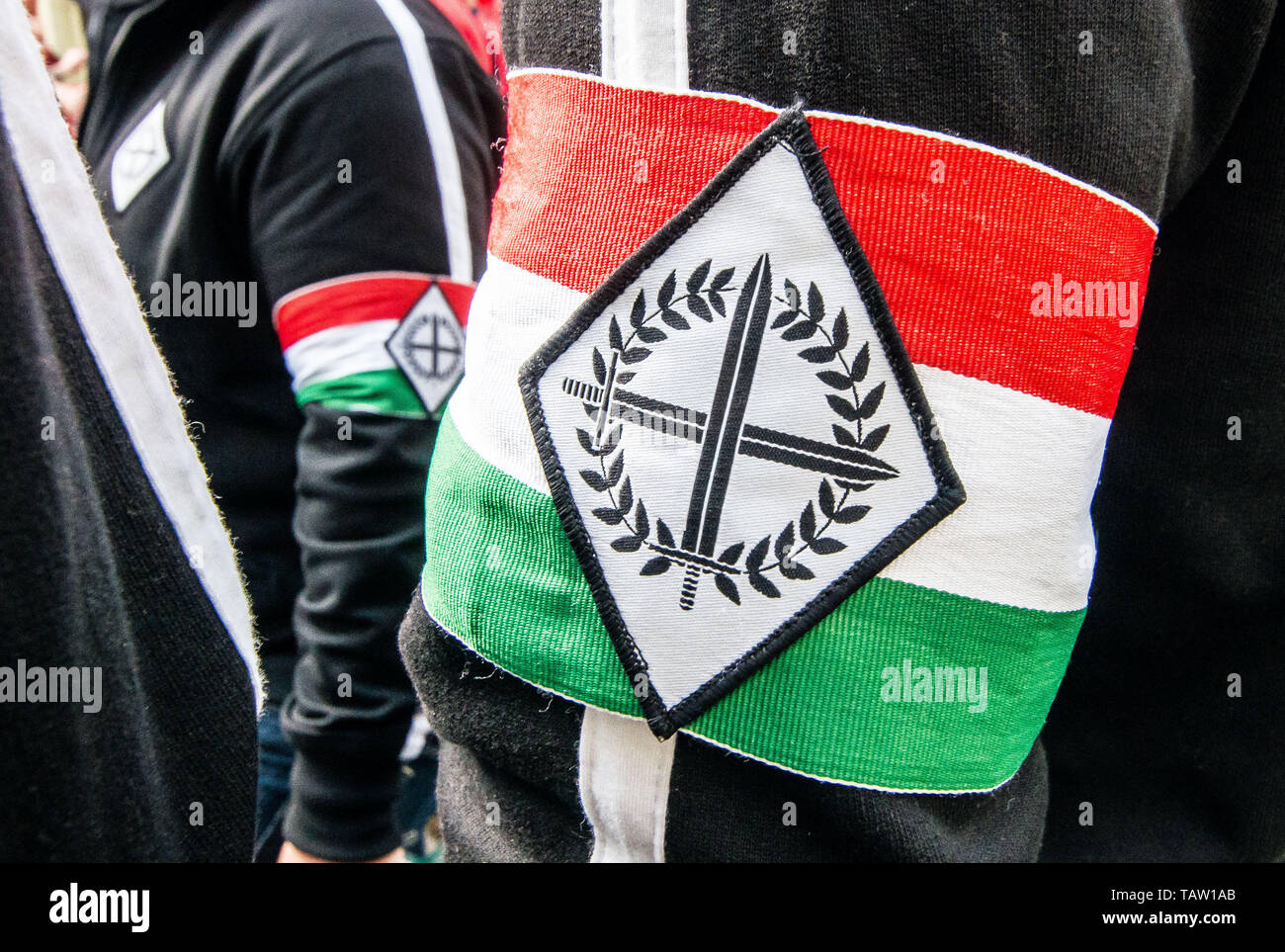 Dortmund, Nordrhein Westfalen, Germany. 25th May, 2019. The symbol of the Legio Hungaria, a Hungarian neonazi group that made an appearance in Dortmund, Germany. Prior to the European Elections, the neonazi party Die Rechte (The Right) organized a rally in the German city of Dortmund to promote their candidate, the incarcerated Holocaust denier Ursula Haverbeck. The demonstration and march were organized by prominent local political figure and neonazi activist Michael Brueck (Michael BrÃ¼ck) who enlisted the help of not only German neonazis, but also assistance from Russian, Bulgarian, Hungar Stock Photo