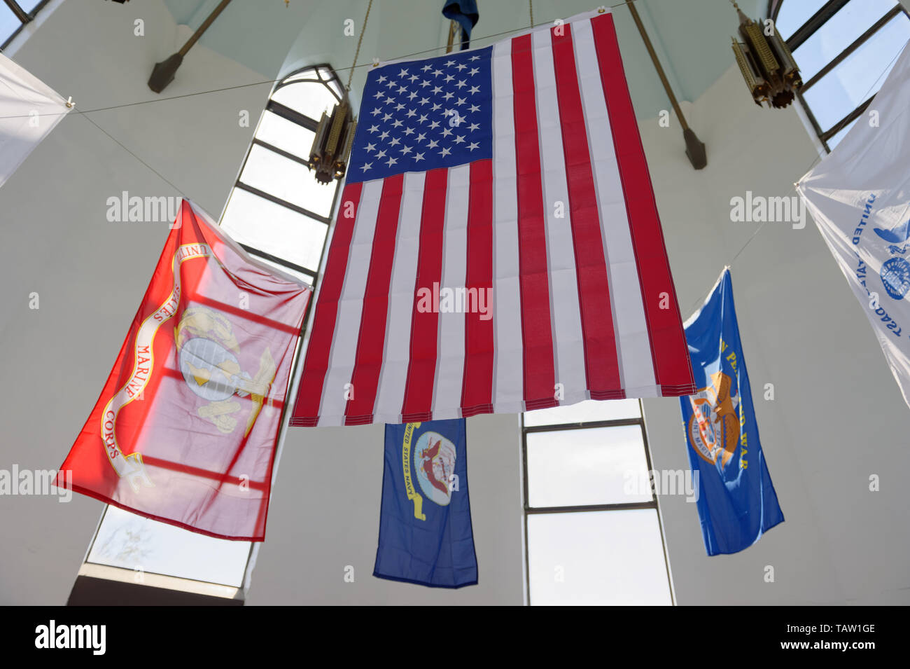 East Meadow, New York, USA. 25th May, 2019. The American Flag and military flags of the United States Armed Forces - Army, Navy, Marine Corps, Air Force, Coast Guard - are suspended in the high ceiling of The Veterans Memorial building, open for visitors during Saturday of Memorial Day Weekend at Eisenhower Park on Long Island. Credit: Ann Parry/ZUMA Wire/Alamy Live News Stock Photo