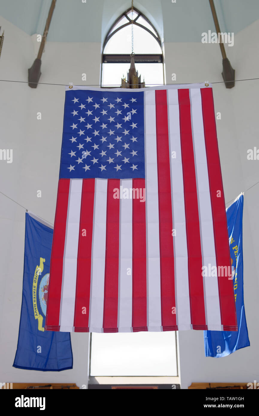 East Meadow, New York, USA. 25th May, 2019. The American Flag and military flags of the United States Armed Forces - Army, Navy, Marine Corps, Air Force, Coast Guard - are suspended in the high ceiling of the Nassau County Veterans Memorial Museum, open for visitors during Saturday of Memorial Day Weekend at Eisenhower Park on Long Island. Credit: Ann Parry/ZUMA Wire/Alamy Live News Stock Photo