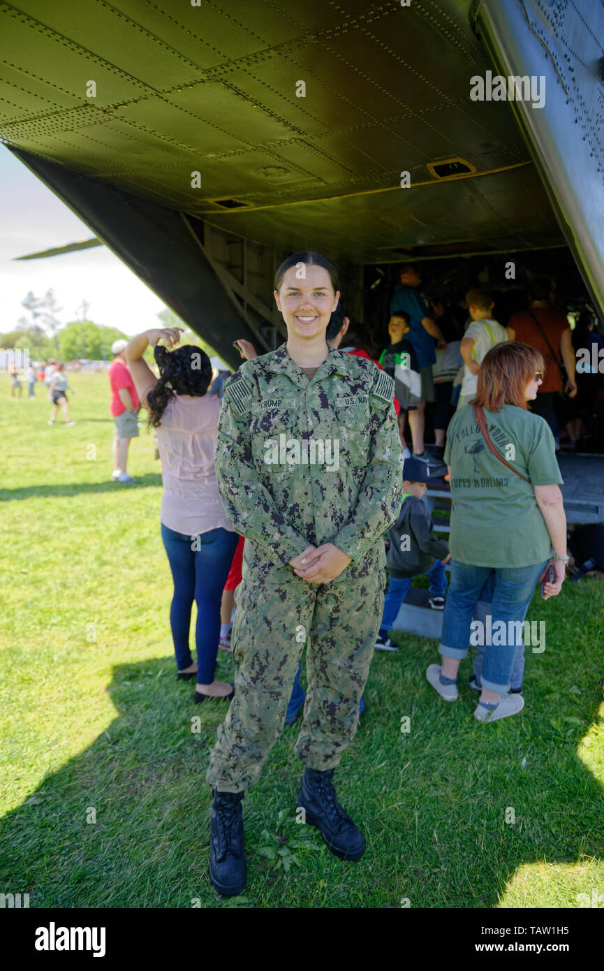 East Meadow, New York, USA. 25th May, 2019. Aviation Electricians Mate Airman (AE) CRUMP poses next to visitors entering the rear entrance of a U.S. Navy MH53-E helicopter at the Navy hosted aviation event, as part of Fleet Week, on Memorial Day Weekend at Eisenhower Park on Long Island. Helicopter Mine Countermeasures Squadron 14 has a Korea deployment mine sweeping. It's the largest helicopter in the Navy, and does long range minesweeping, AKA Airborne Mine Countermeasures (AMCM) missions, and carries heavy loads and transports and picks up things for the Navy. (Credit Image: © An Stock Photo
