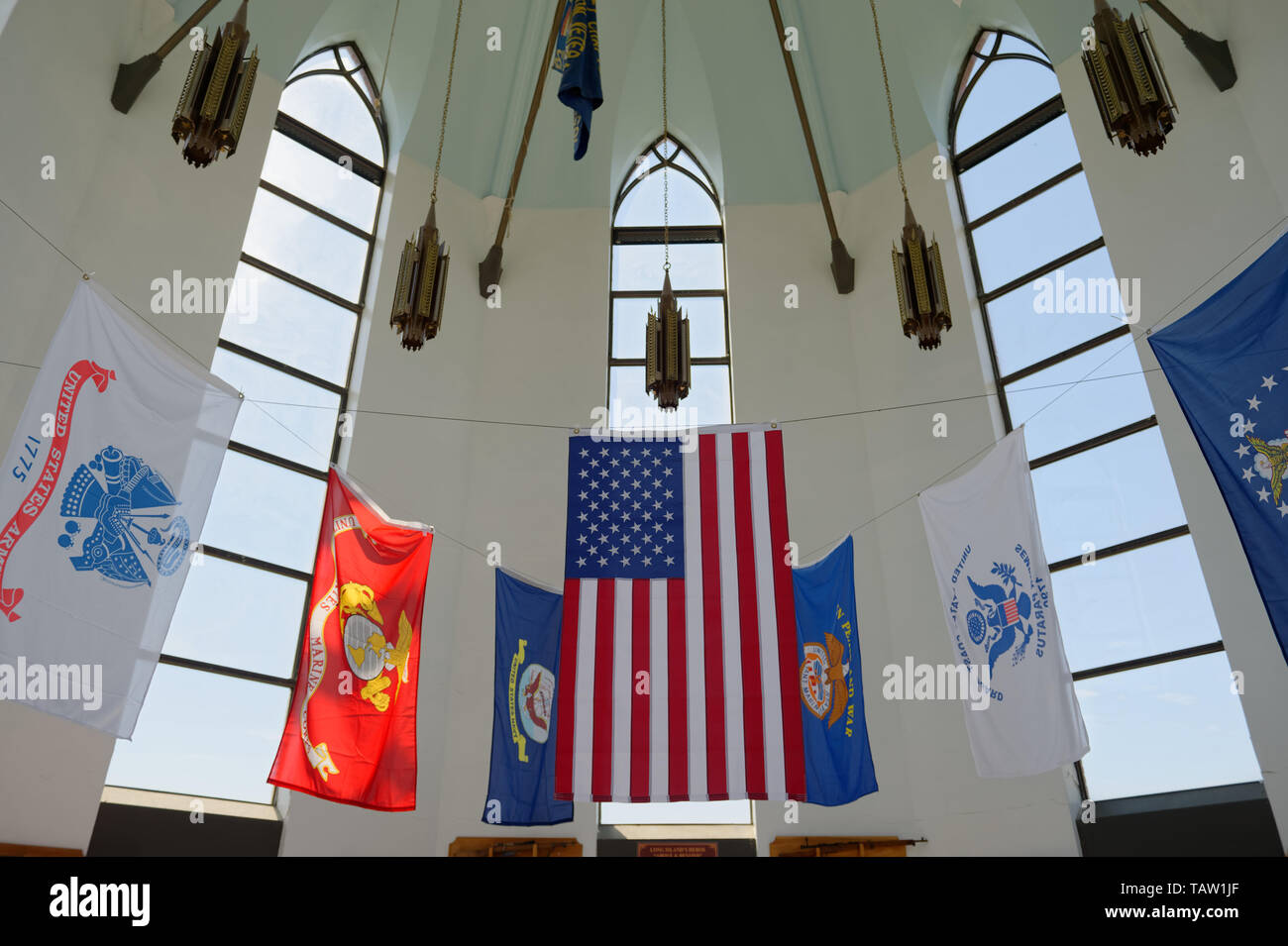 East Meadow, New York, USA. 25th May, 2019. The American Flag and military flags of the United States Armed Forces - Army, Navy, Marine Corps, Air Force, Coast Guard - are suspended in the high ceiling of the Nassau County Veterans Memorial Museum, open for visitors during Saturday of Memorial Day Weekend at Eisenhower Park on Long Island. Credit: Ann Parry/ZUMA Wire/Alamy Live News Stock Photo