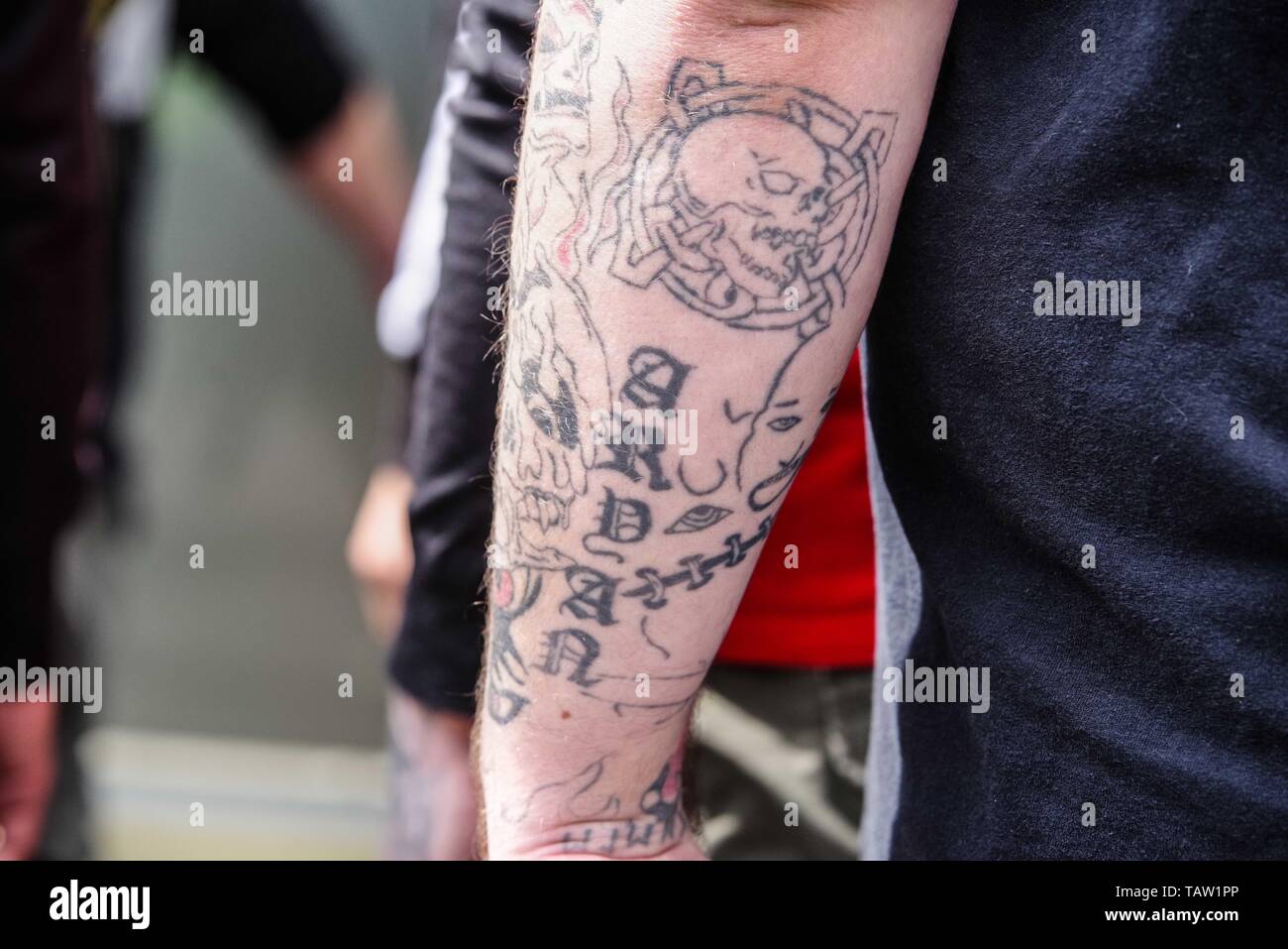 Dortmund, Nordrhein Westfalen, Germany. 25th May, 2019. A neonazi in Dortmund, Germany with an ''Aryan'' tattoo which could signify his membership with the prison gang. Prior to the European Elections, the neonazi party Die Rechte (The Right) organized a rally in the German city of Dortmund to promote their candidate, the incarcerated Holocaust denier Ursula Haverbeck. The demonstration and march were organized by prominent local political figure and neonazi activist Michael Brueck (Michael BrÃ¼ck) who enlisted the help of not only German neonazis, but also assistance from Russian, Bulgarian Stock Photo