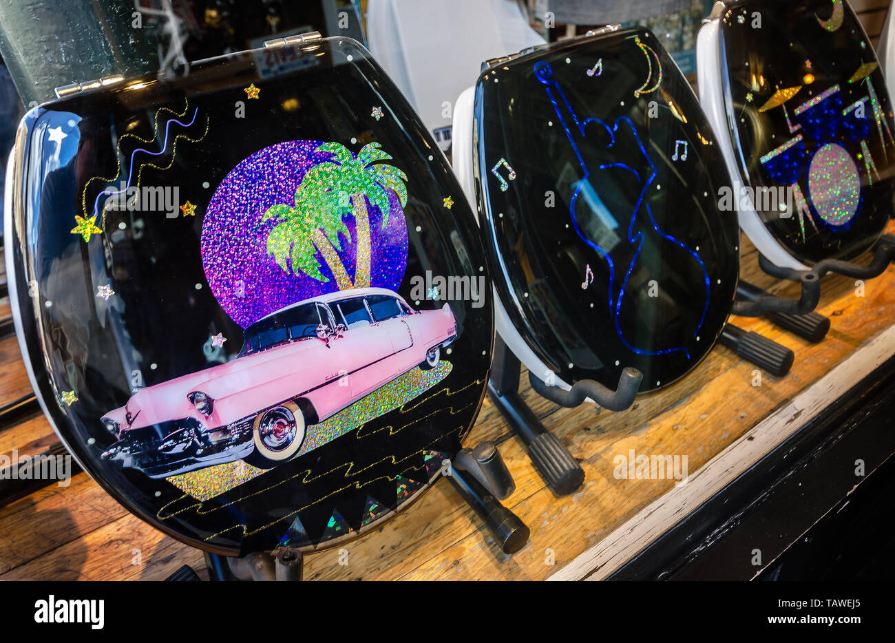 Music-themed, painted toilet seats, decorated with pink Cadillacs and guitars, line a shop window at Memphis Music in Memphis, Tennessee. Stock Photo