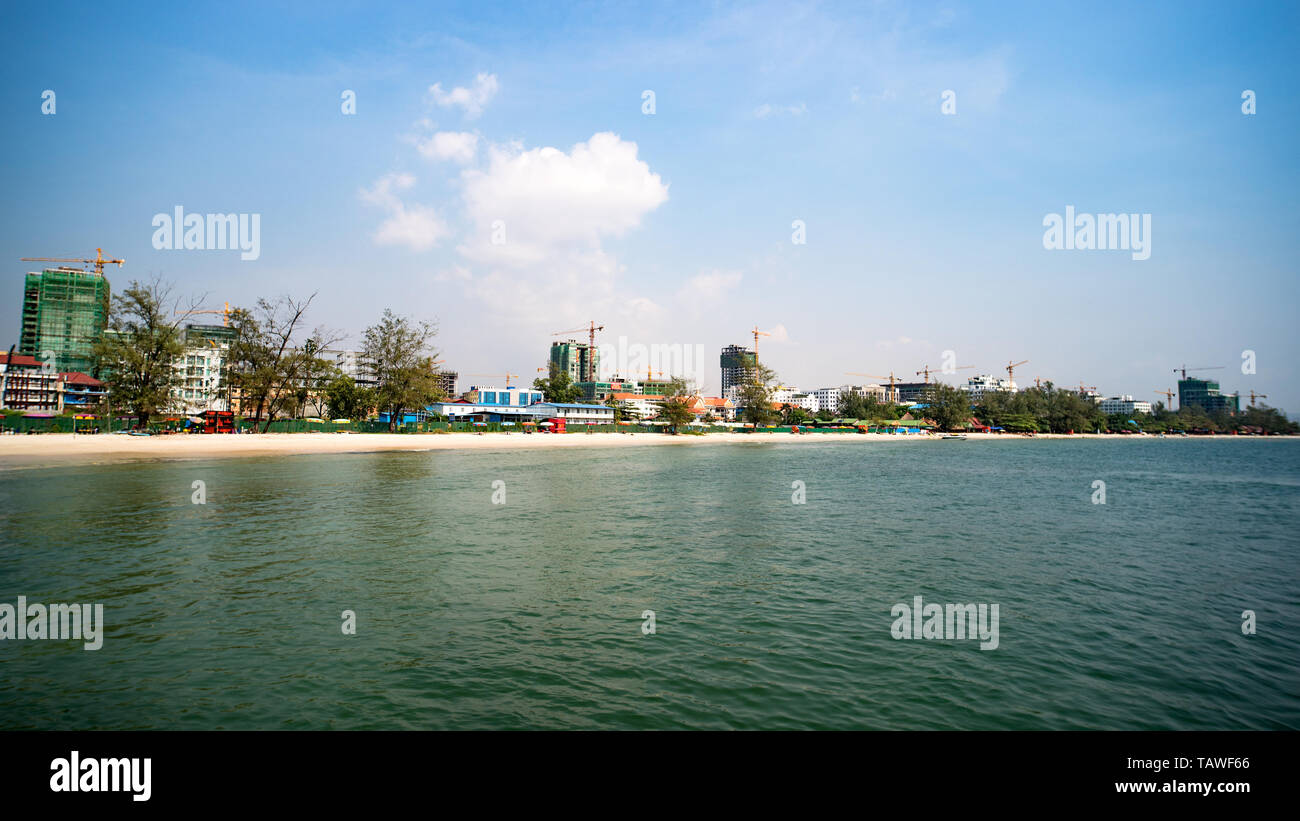 Construction of multi-storey buildings in Cambodia, Sihanoukville. Modern high-rise buildings under construction. Beach with white sand in the city. M Stock Photo