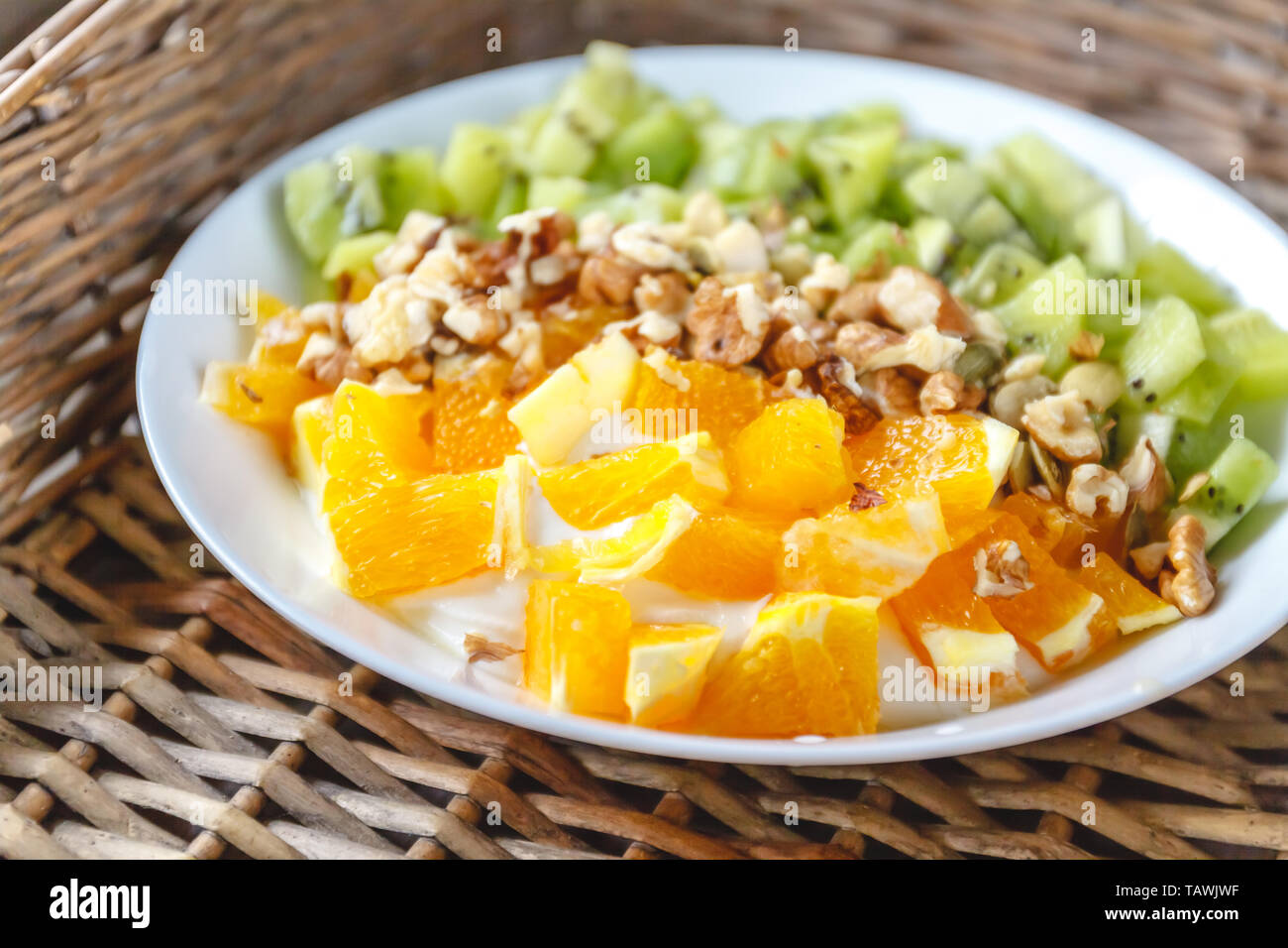 Cottage Cheese And Creamy Dessert With Orange Kiwi Nuts On A