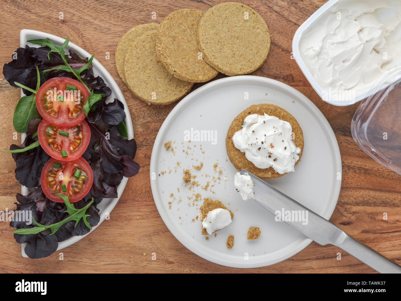 Dairy free cream cheese on oatcakes served with salad Stock Photo