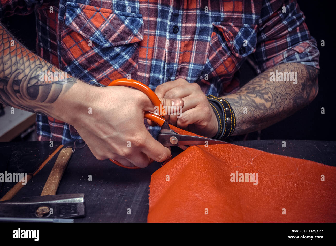 Leather Professional making quality products in his workshop. Stock Photo