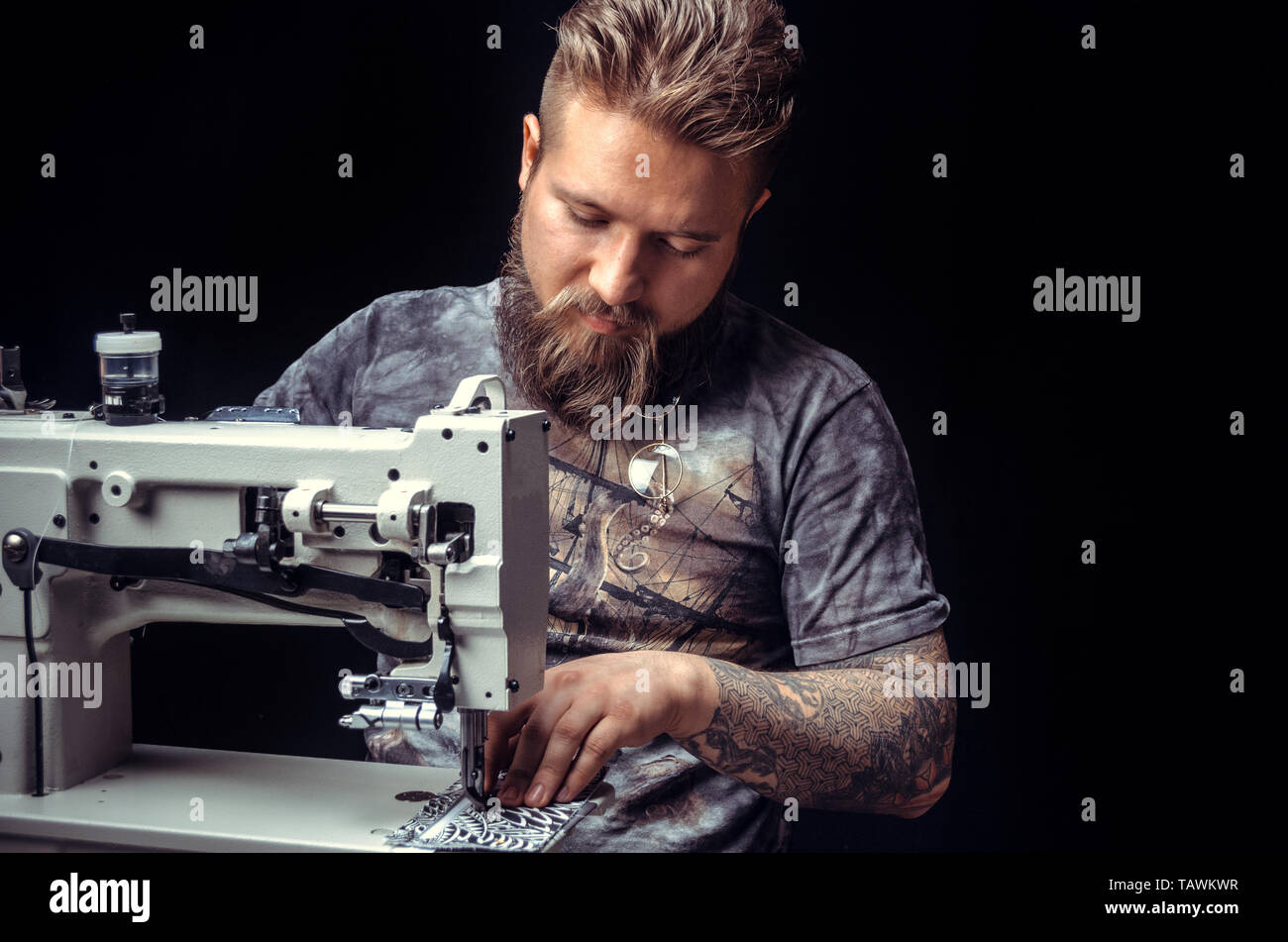 Man working with leather creating new leatherwork . Stock Photo