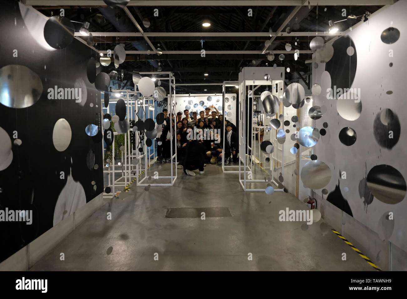 songshan tobacco factory Visitors inside a ware house of a former tobacco factory converted into a  gallery space at a multi-functional cultural complex named Songshan  Cultural and Creative Park which its aim is to establish