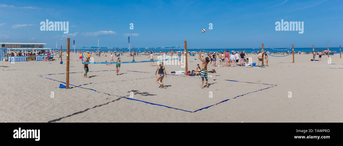 Panorama of people playing beach volleyball in Valencia, Spain Stock