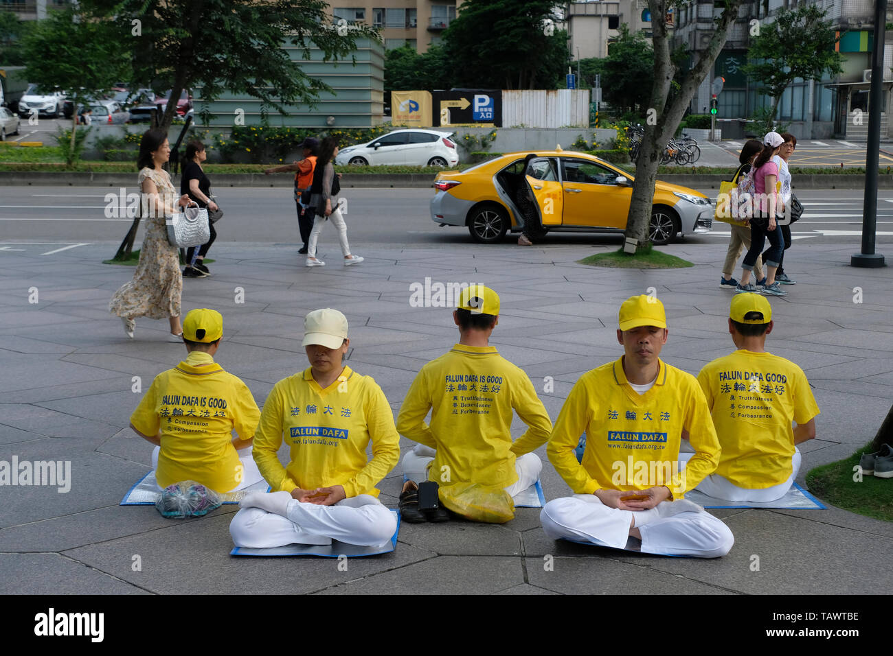 Falun Gong practitioners meditate to protest the persecution of Falun Gong  at a demonstration in Taipei Taiwan Stock Photo - Alamy