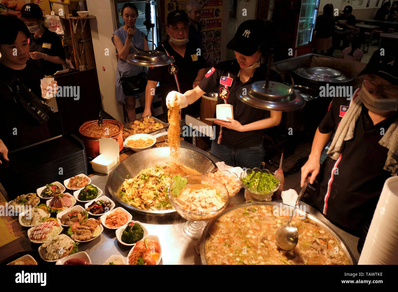 Vendor selling traditional Chinese food in Raohe Street Night Market ...