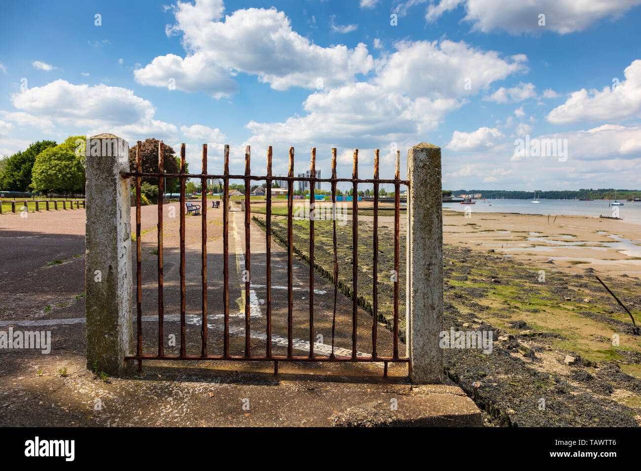 A rusty iron fence placed to stop users of The Strand Promenade in Gillingham from falling gives an  attractive view to the scene, Kent, UK Stock Photo