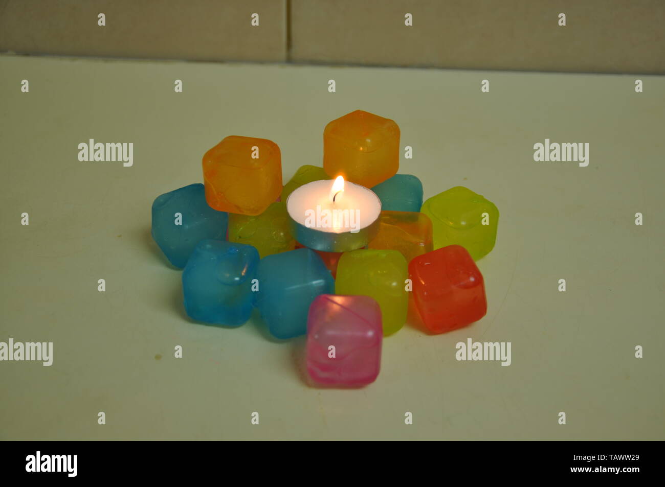 A candle is lit on ice cubes Stock Photo Alamy