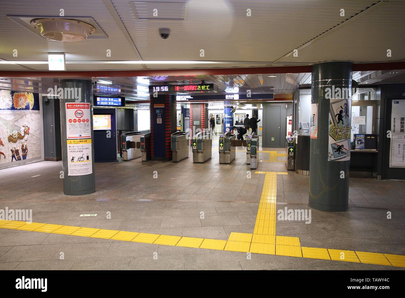 TOKYO, JAPAN - APRIL 13, 2012: People enter Tokyo Metro. With more than 3.1 billion annual passenger rides, Tokyo subway system is the busiest worldwi Stock Photo