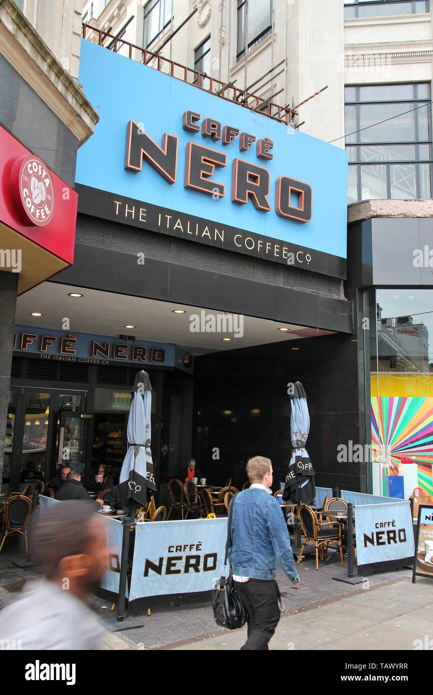 MANCHESTER, UK - APRIL 21, 2013: People drink coffee at Caffe Nero in Manchester, UK. Caffe Nero was founded in 1997 and has 700 coffee houses in 7 co Stock Photo