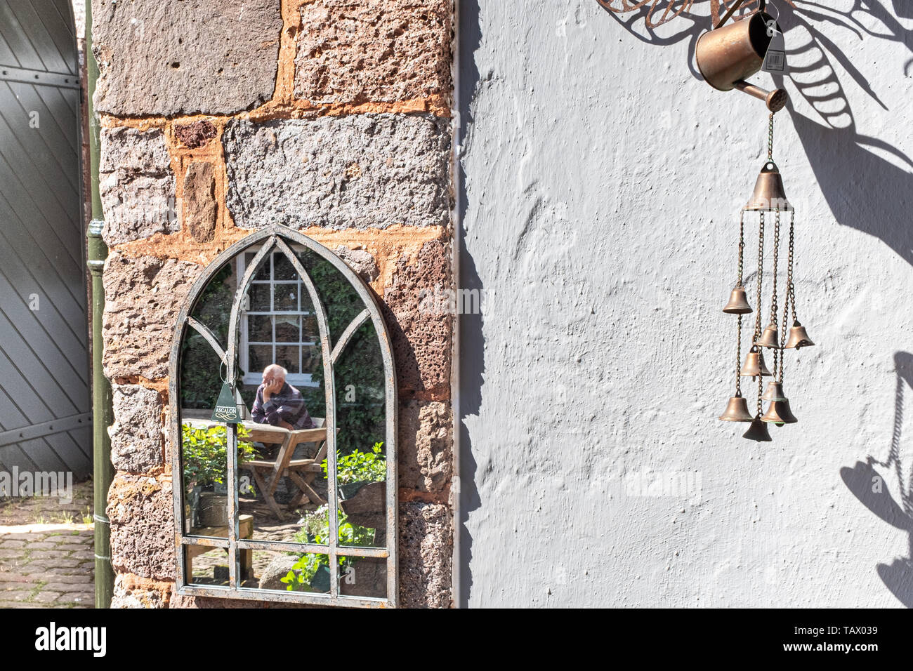 Mirror on a wall, Killerton garden centre, National Trust, Killerton, Devon, UK Stock Photo
