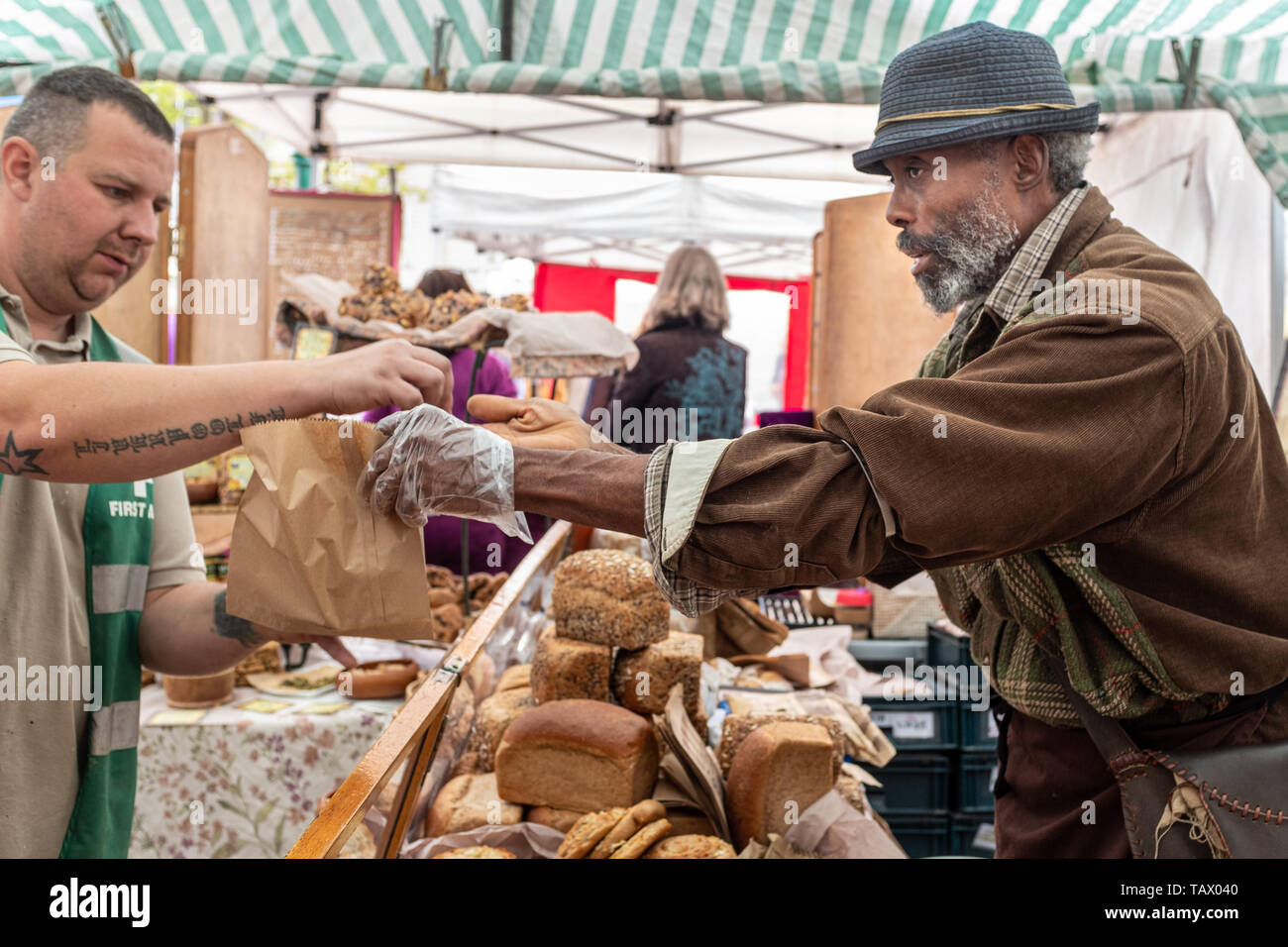 Specialist baker selling bread at Totnes Market, Totnes, Devon, UK Stock Photo