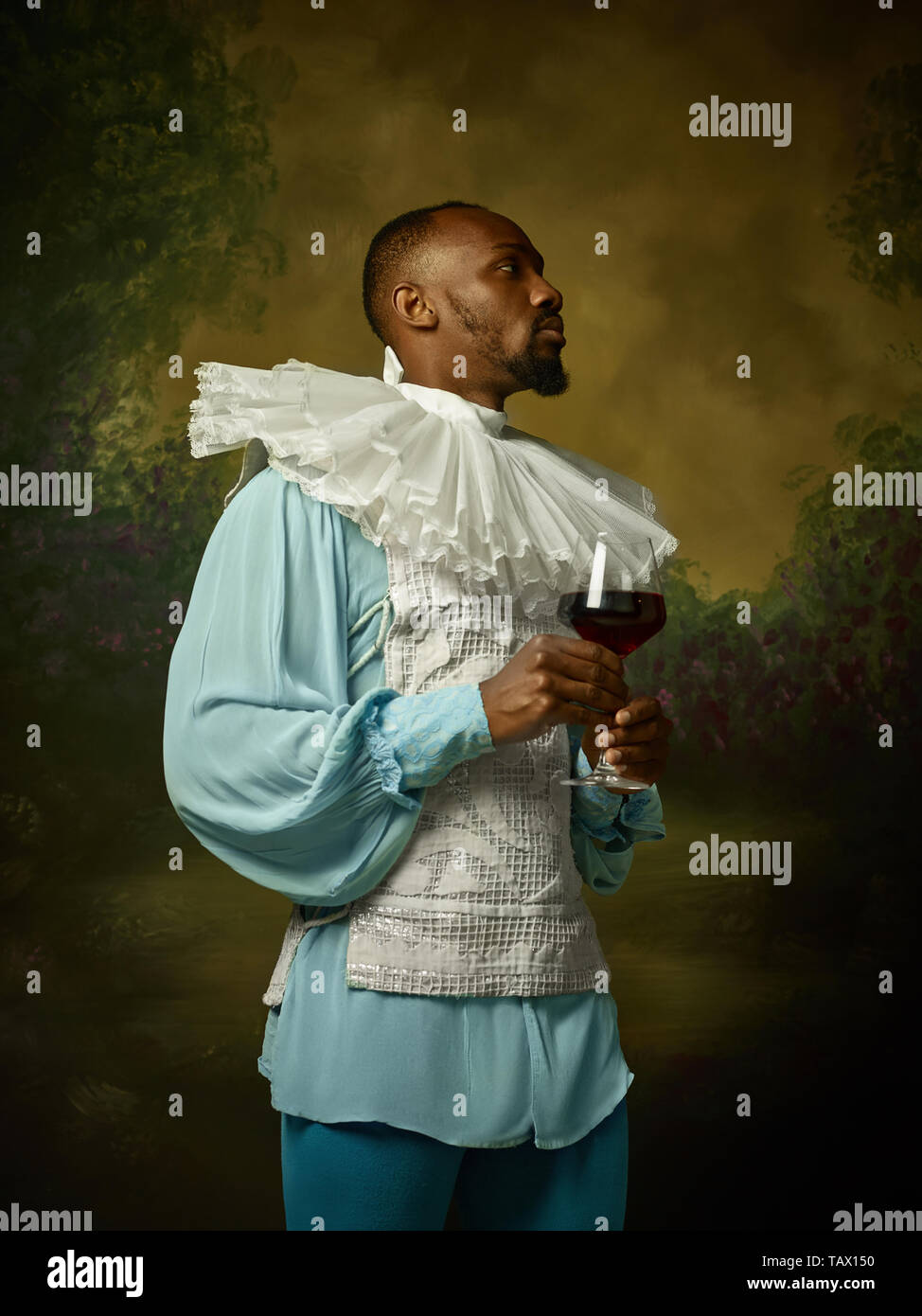 Grandee Young man as a medieval grandee or nobleman on dark studio background ...
