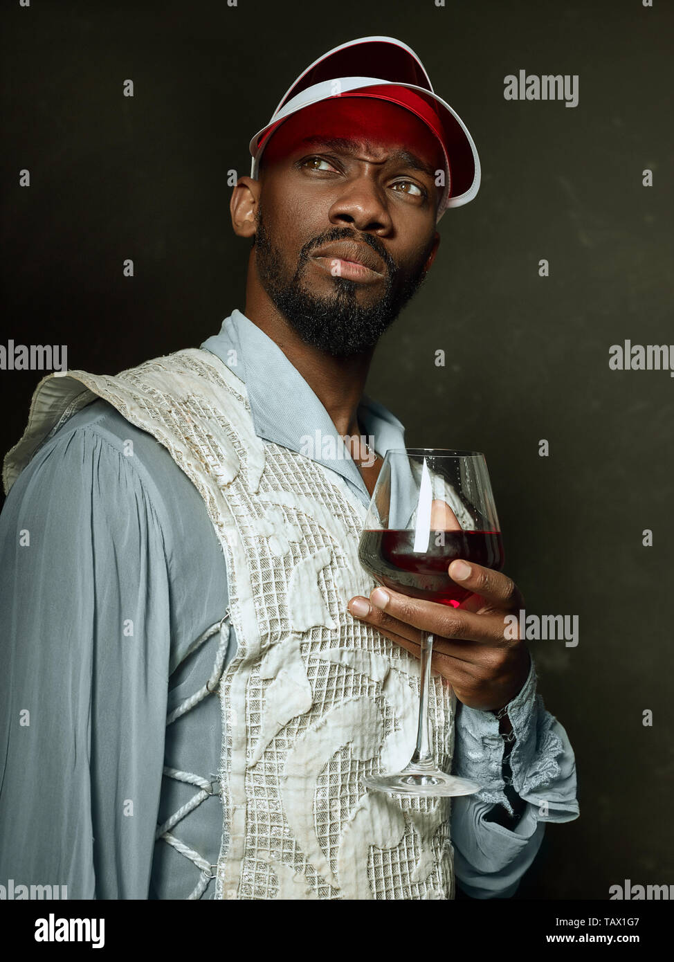 Grandee Young man as a medieval grandee or nobleman on dark studio background ...